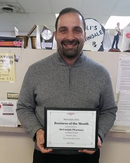 Founder Ali Elhasan holding the framed plaque: Melvindale DDA Business of the Month, awarded to Melvindale Pharmacy, Ali Elhasan and Staff, February 2016