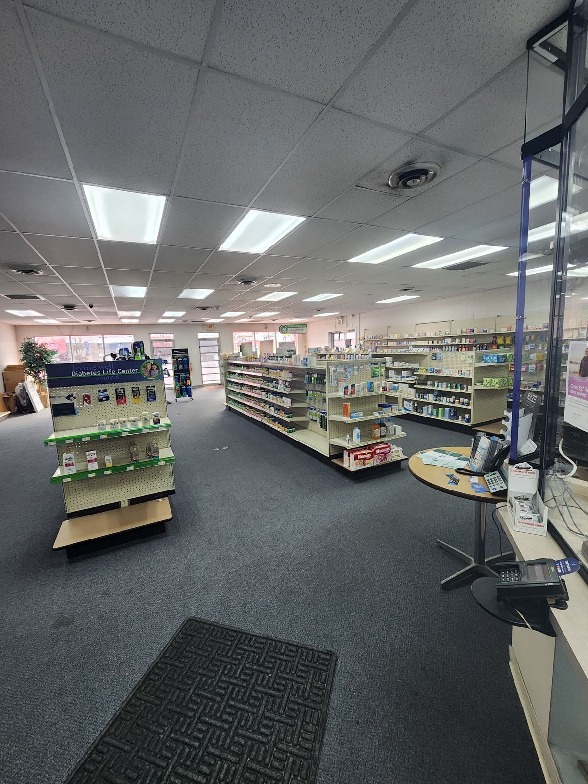 Inside Melvindale Pharmacy: shelves of health products along the aisles